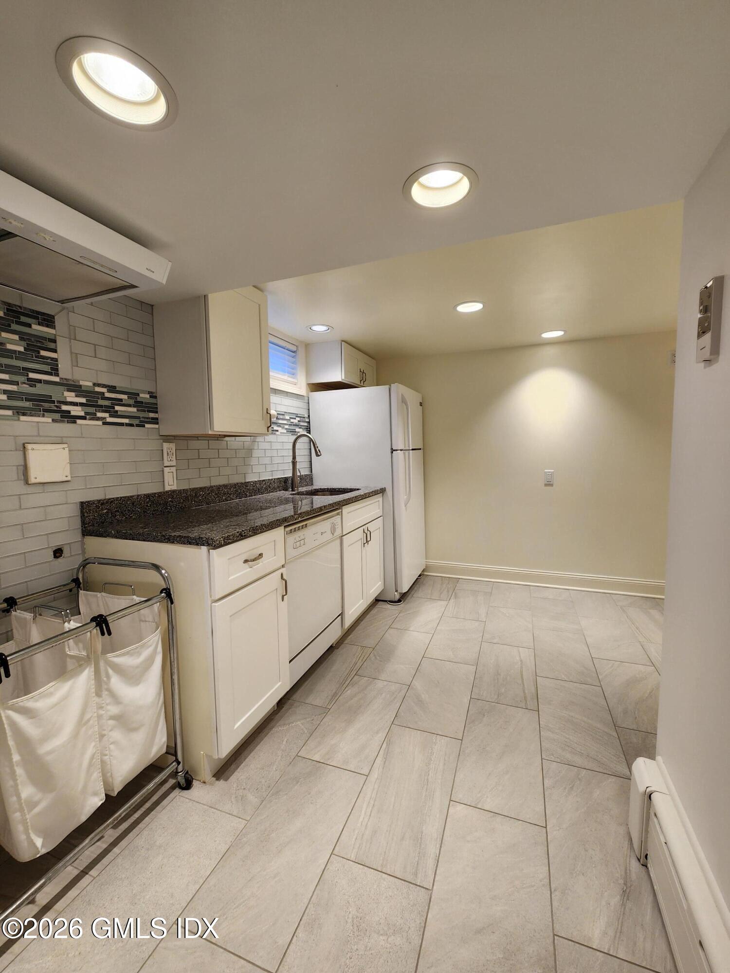 34 Harold Street Cos Cob, CT 06807 - Photo 23 of 25 a kitchen with stainless steel appliances granite countertop a sink and cabinets
