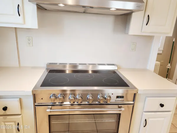 a view of a room with wooden floor and a bathroom