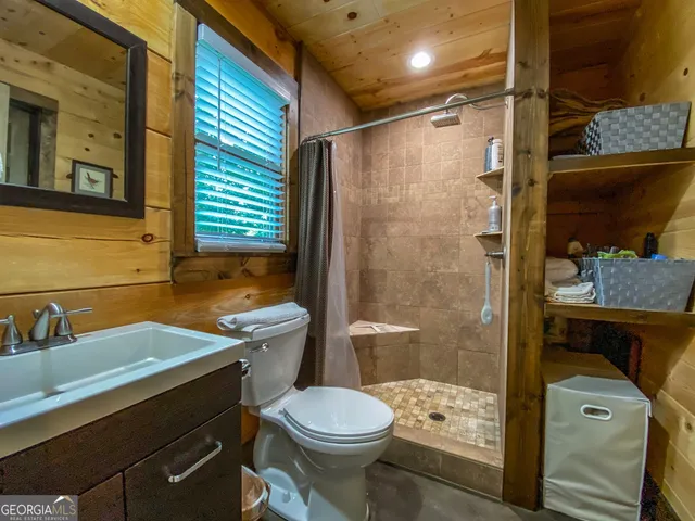 a bedroom with a large bed and dresser