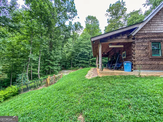 a view of a wooden deck with a yard