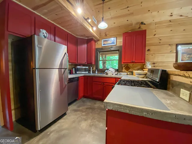 a kitchen with a refrigerator a stove a sink dishwasher and a refrigerator