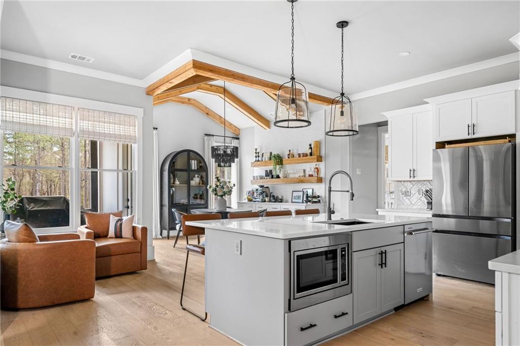 8215 Highway 81 Bethlehem, GA 30620 - Photo 13 of 60 a kitchen with stainless steel appliances granite countertop a sink a stove and a refrigerator