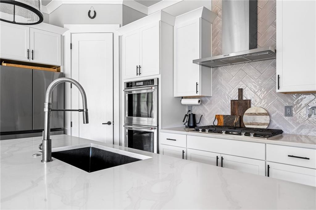 8215 Highway 81 Bethlehem, GA 30620 - Photo 15 of 60 a kitchen with stainless steel appliances kitchen island granite countertop a refrigerator and a stove top oven