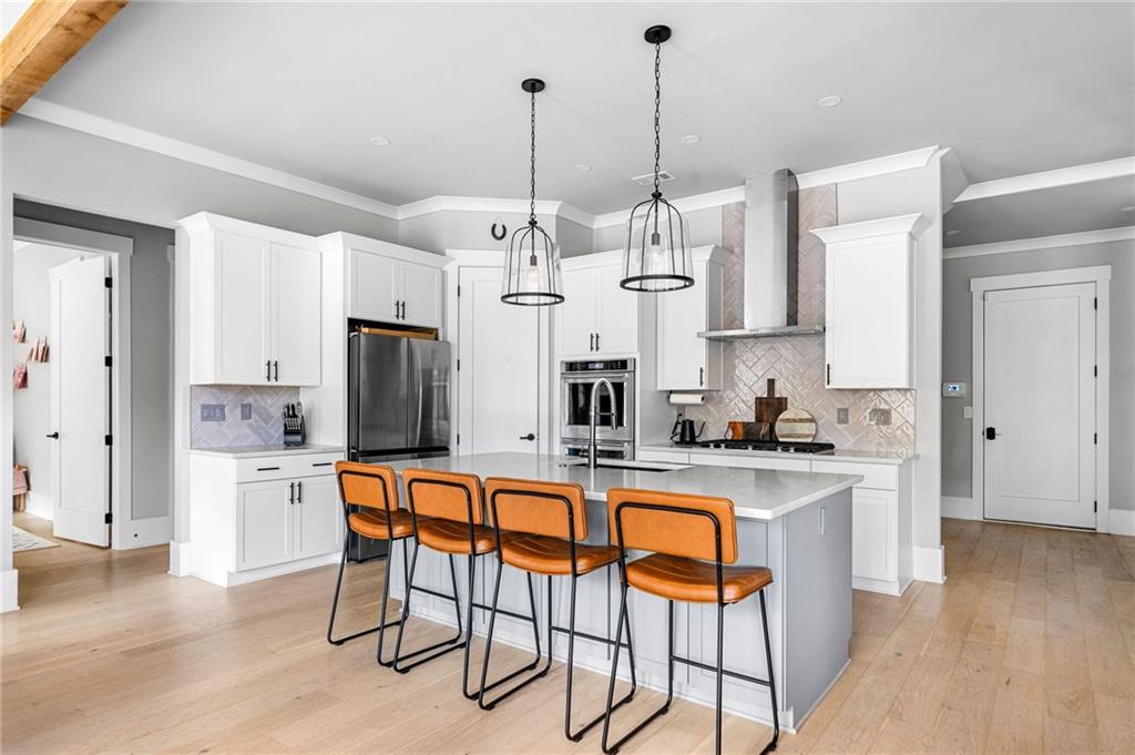 8215 Highway 81 Bethlehem, GA 30620 - Photo 16 of 60 a view of a kitchen with kitchen island granite countertop wooden floor and stainless steel appliances