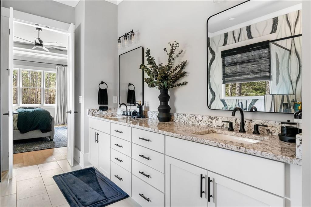 8215 Highway 81 Bethlehem, GA 30620 - Photo 22 of 57 a bathroom with double vanity and a mirror