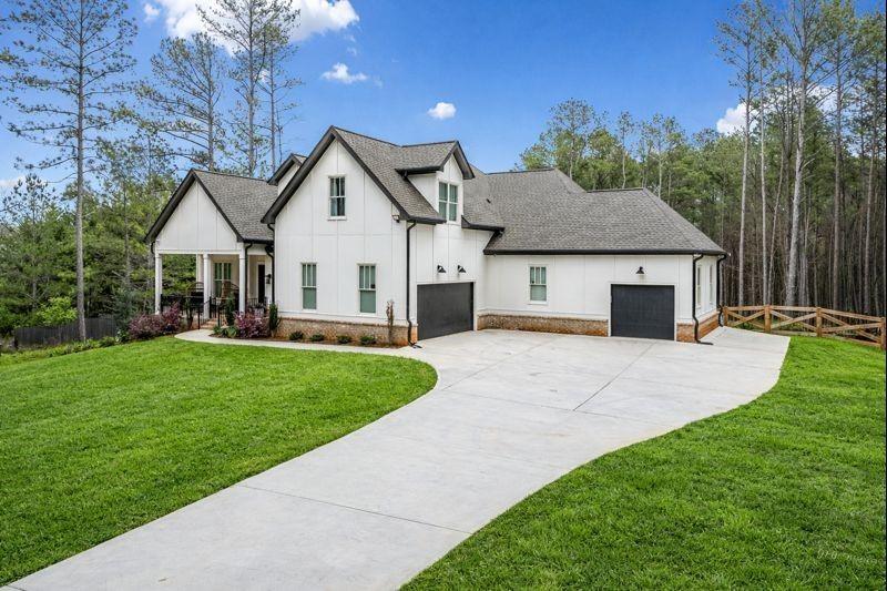 8215 Highway 81 Bethlehem, GA 30620 - Photo 3 of 57 a front view of a house with a garden and yard