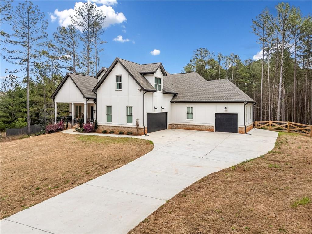 8215 Highway 81 Bethlehem, GA 30620 - Photo 3 of 60 a front view of a house with a yard and garage