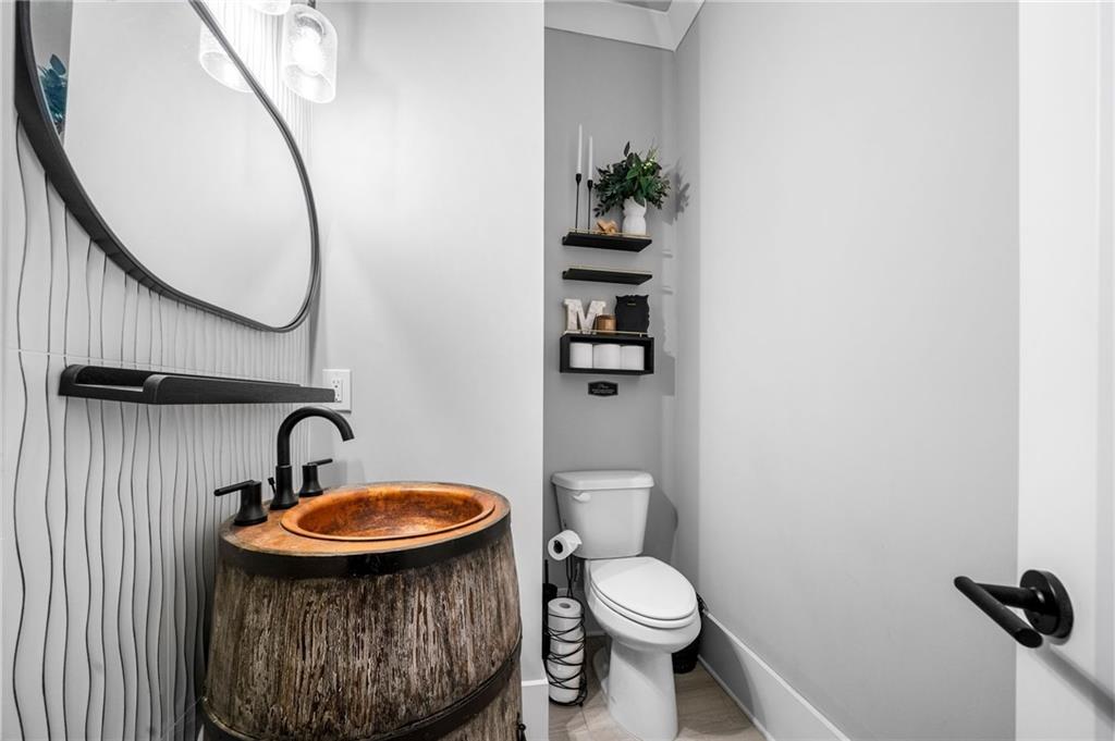 8215 Highway 81 Bethlehem, GA 30620 - Photo 32 of 60 a bathroom with a sink a toilet and a mirror