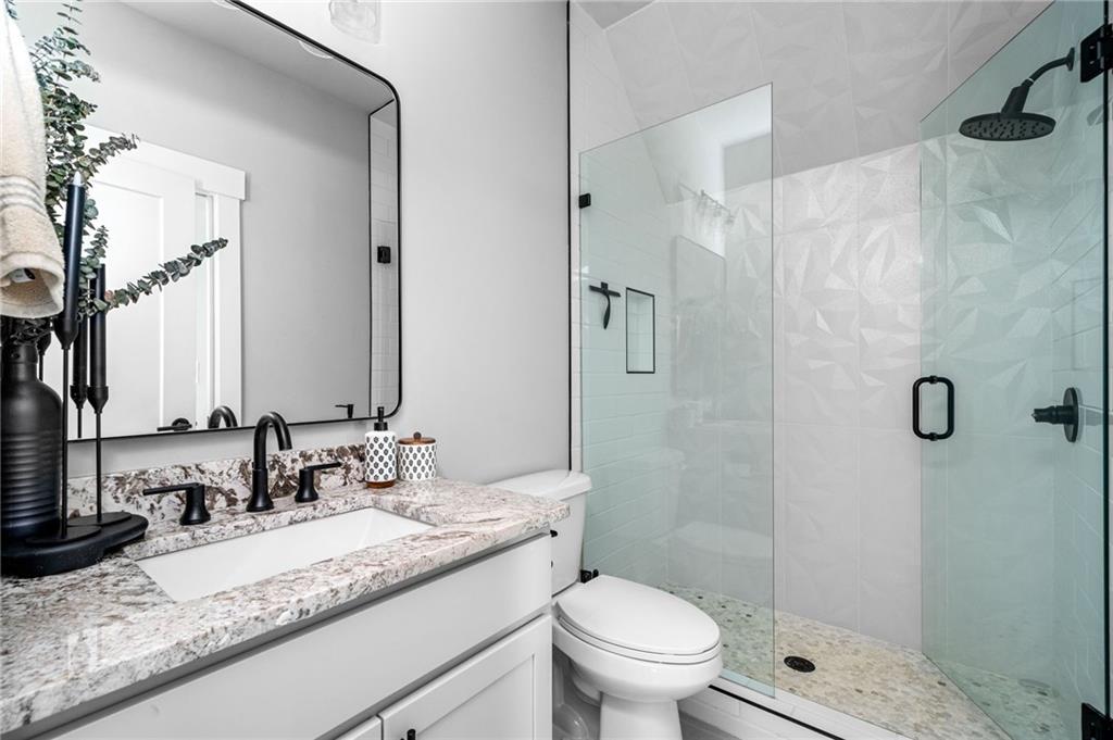 8215 Highway 81 Bethlehem, GA 30620 - Photo 34 of 57 a bathroom with a granite countertop sink toilet and shower