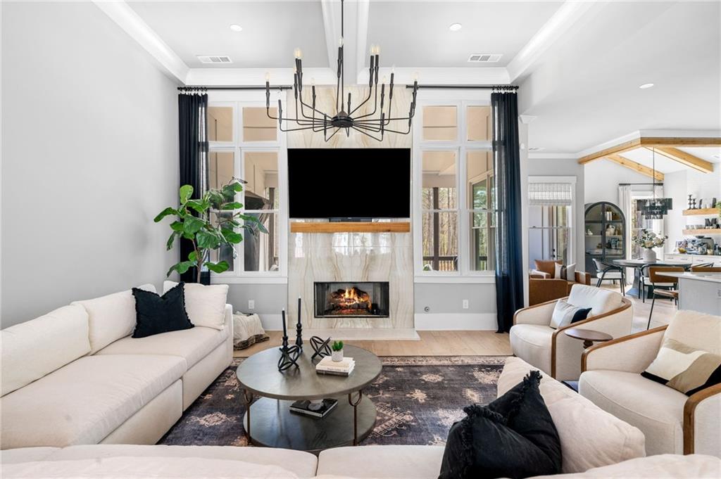 8215 Highway 81 Bethlehem, GA 30620 - Photo 9 of 60 a living room with furniture a fireplace and a flat screen tv