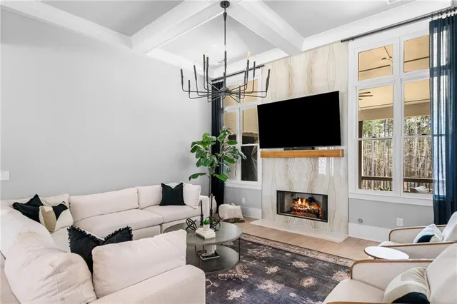 a living room with fireplace furniture and a flat screen tv