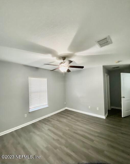 3949 Ringneck Drive Jacksonville, FL 32226 - Photo 11 of 16 an empty room with wooden floor chandelier fan and windows