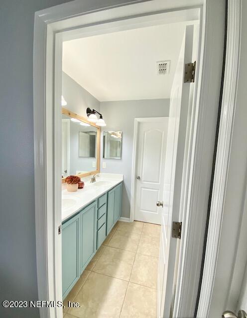 3949 Ringneck Drive Jacksonville, FL 32226 - Photo 12 of 16 a bathroom with a sink and mirror with bathtub