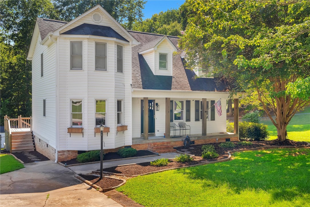 A welcoming front porch and classic siding define this charming multi-level residence.