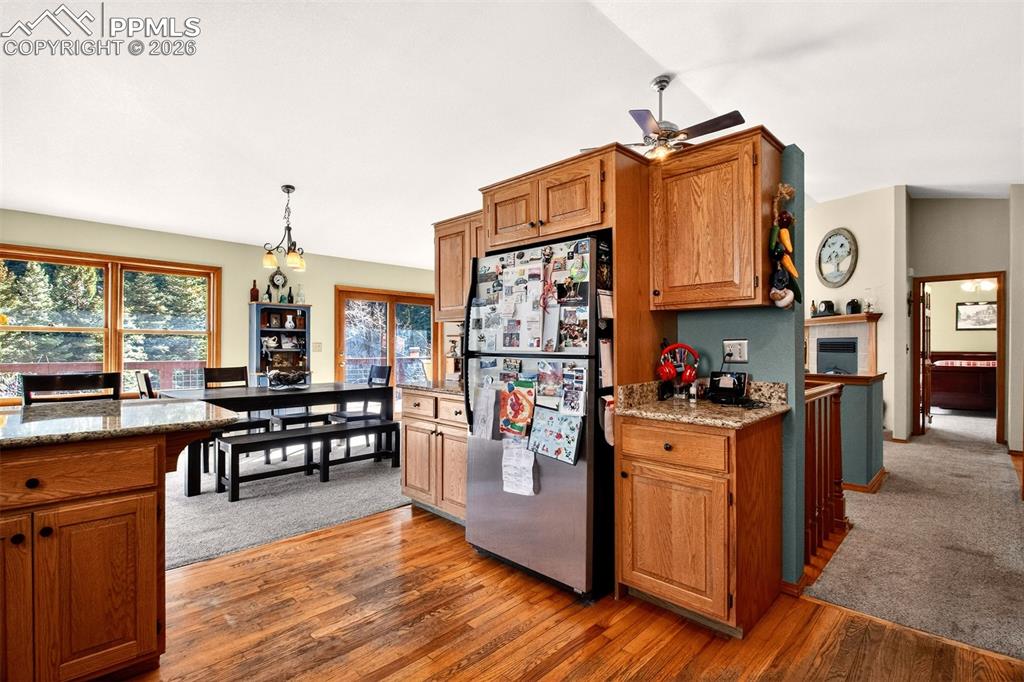 1445 Sutherland Creek Road Manitou Springs, CO 80829 - Photo 14 of 43 a kitchen with stainless steel appliances granite countertop a stove and a wooden floors