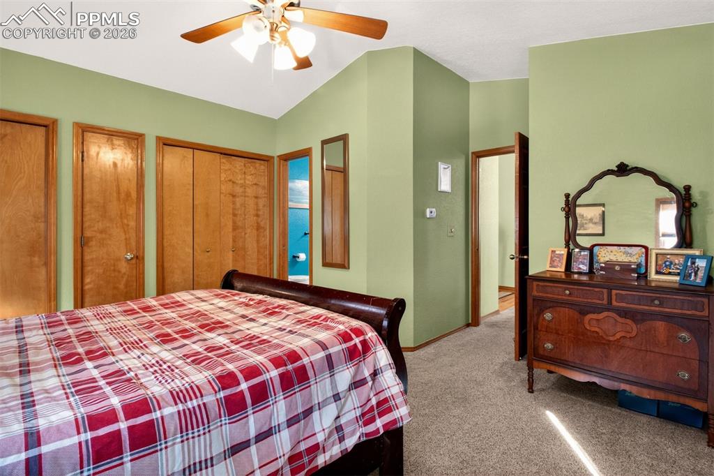 1445 Sutherland Creek Road Manitou Springs, CO 80829 - Photo 18 of 43 a bedroom with a bed and a mirror