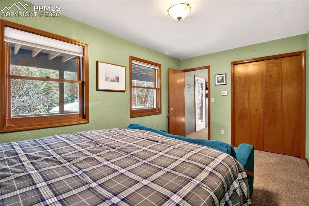 1445 Sutherland Creek Road Manitou Springs, CO 80829 - Photo 29 of 43 a bedroom with a bed and a window