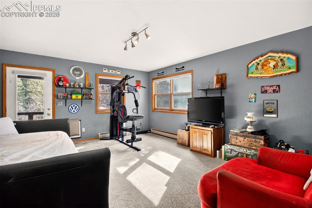 1445 Sutherland Creek Road Manitou Springs, CO 80829 - Photo 30 of 43 a living room with furniture and a flat screen tv