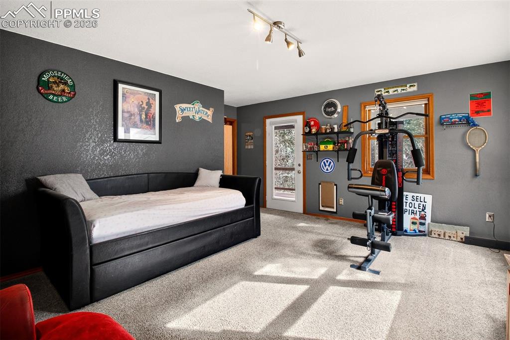 1445 Sutherland Creek Road Manitou Springs, CO 80829 - Photo 32 of 43 a bedroom with bed and a desk