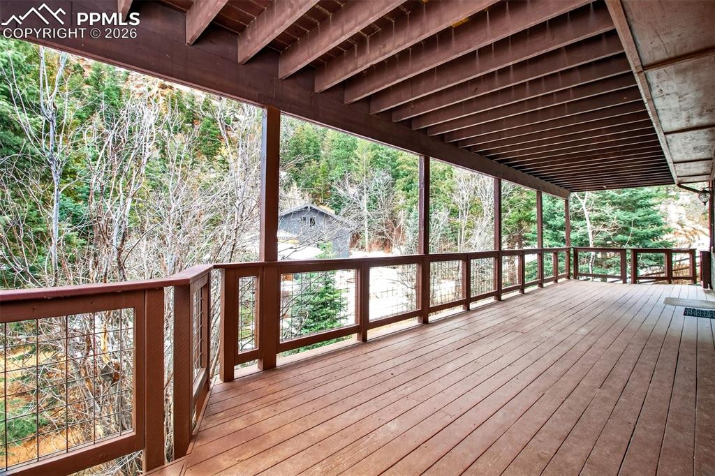 1445 Sutherland Creek Road Manitou Springs, CO 80829 - Photo 35 of 43 a porch with wooden floor in outdoor space