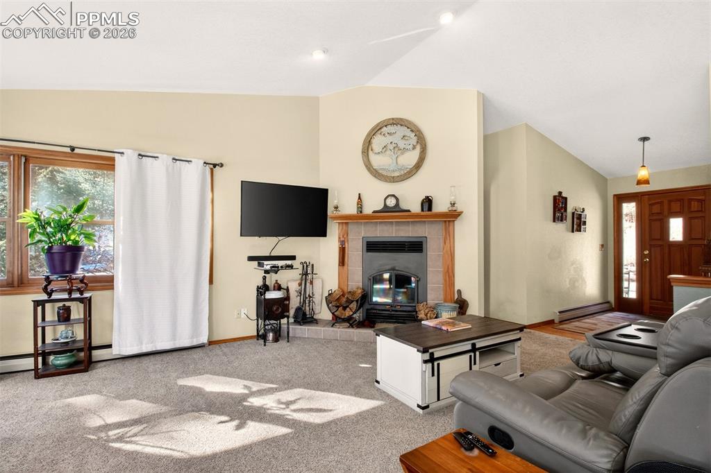 1445 Sutherland Creek Road Manitou Springs, CO 80829 - Photo 6 of 43 a living room with furniture a window and a flat screen tv