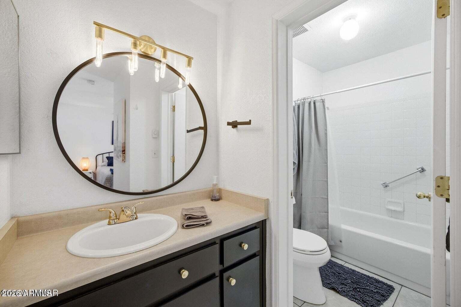 2700 South White Mountain Road, Unit 404 Show Low, AZ 85901 - Photo 14 of 20 a bathroom with a sink a toilet and a mirror