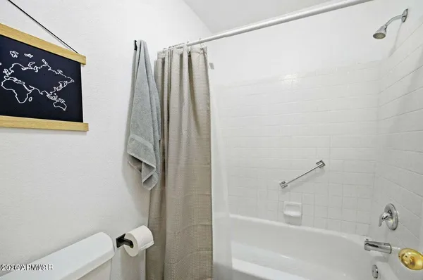 a bathroom with a shower and a tub
