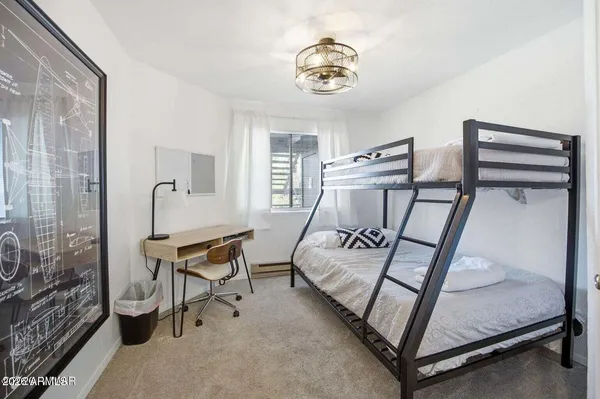 a bedroom with furniture and a window
