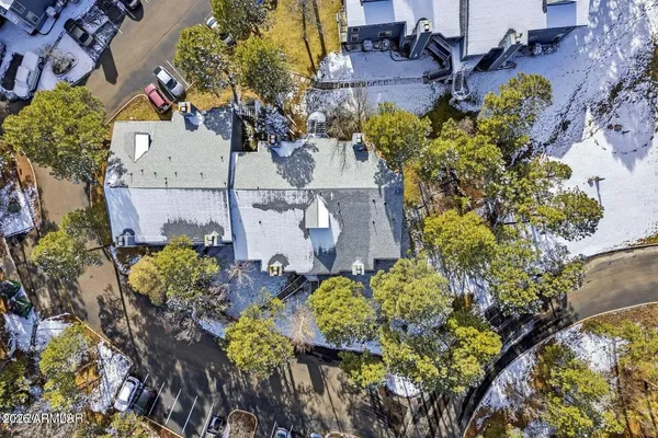 an aerial view of a house with a yard and garden