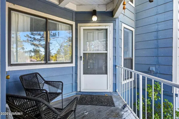 a view of a balcony with furniture