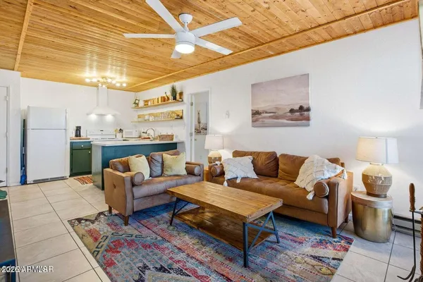 a living room with furniture and a chandelier
