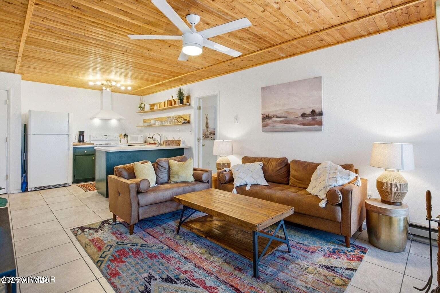 2700 South White Mountain Road, Unit 404 Show Low, AZ 85901 - Photo 6 of 20 a living room with furniture and a chandelier