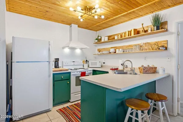 a kitchen with stainless steel appliances granite countertop a sink and a refrigerator