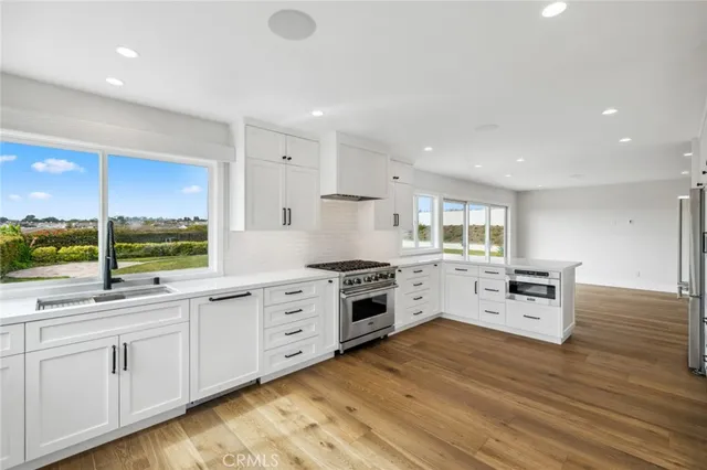 a kitchen with white cabinets and white appliances