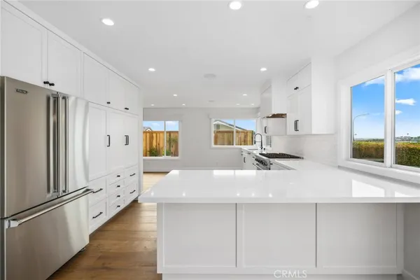 a kitchen with refrigerator and window