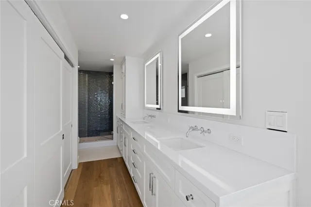 a bathroom with a sink a mirror and a bathtub