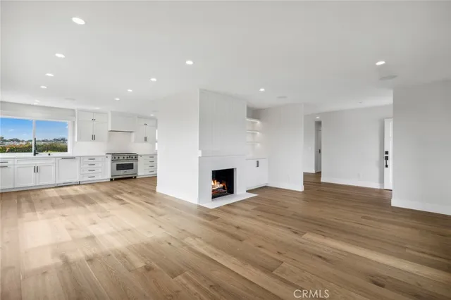 a view of a kitchen with kitchen island wooden floor and living room