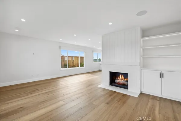 a view of a room with wooden floor and fireplace