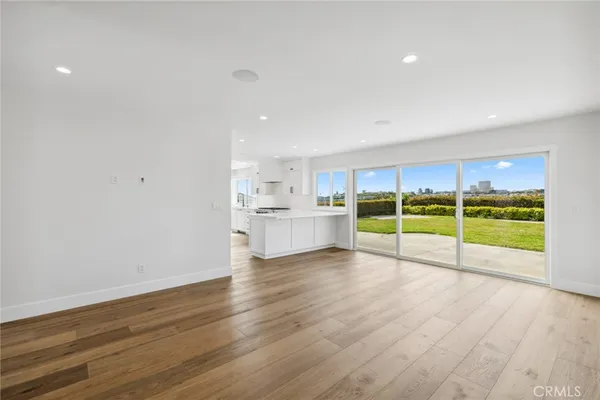 a view of a kitchen with wooden floor and a sink