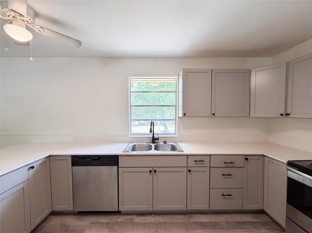 205 West Decatur Street Chico, TX 76431 - Photo 5 of 19 a kitchen with white cabinets