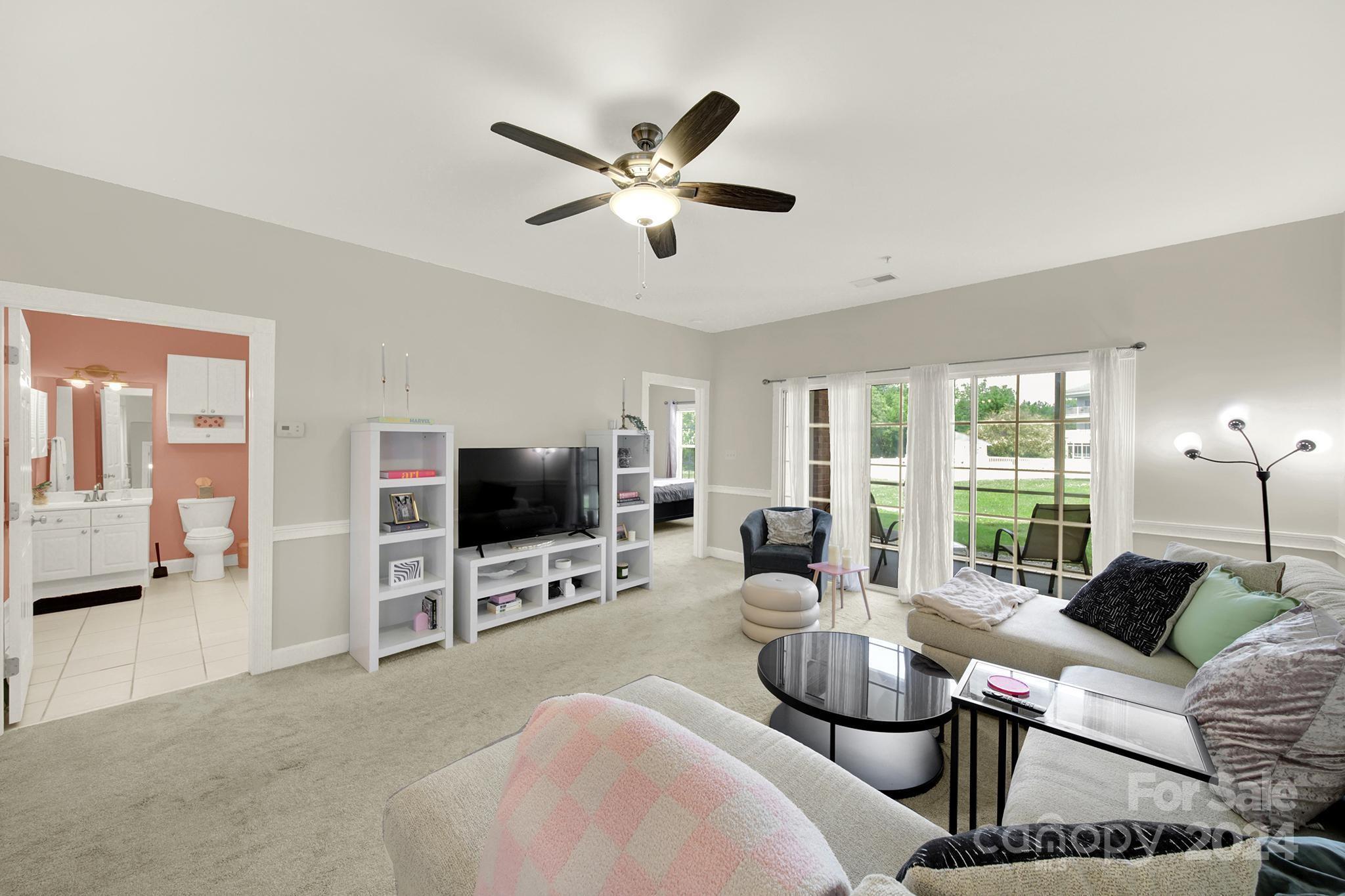 8959 Meadow Vista Road Charlotte, NC 28213 - Photo 14 of 32 a living room with furniture a ceiling fan and a flat screen tv
