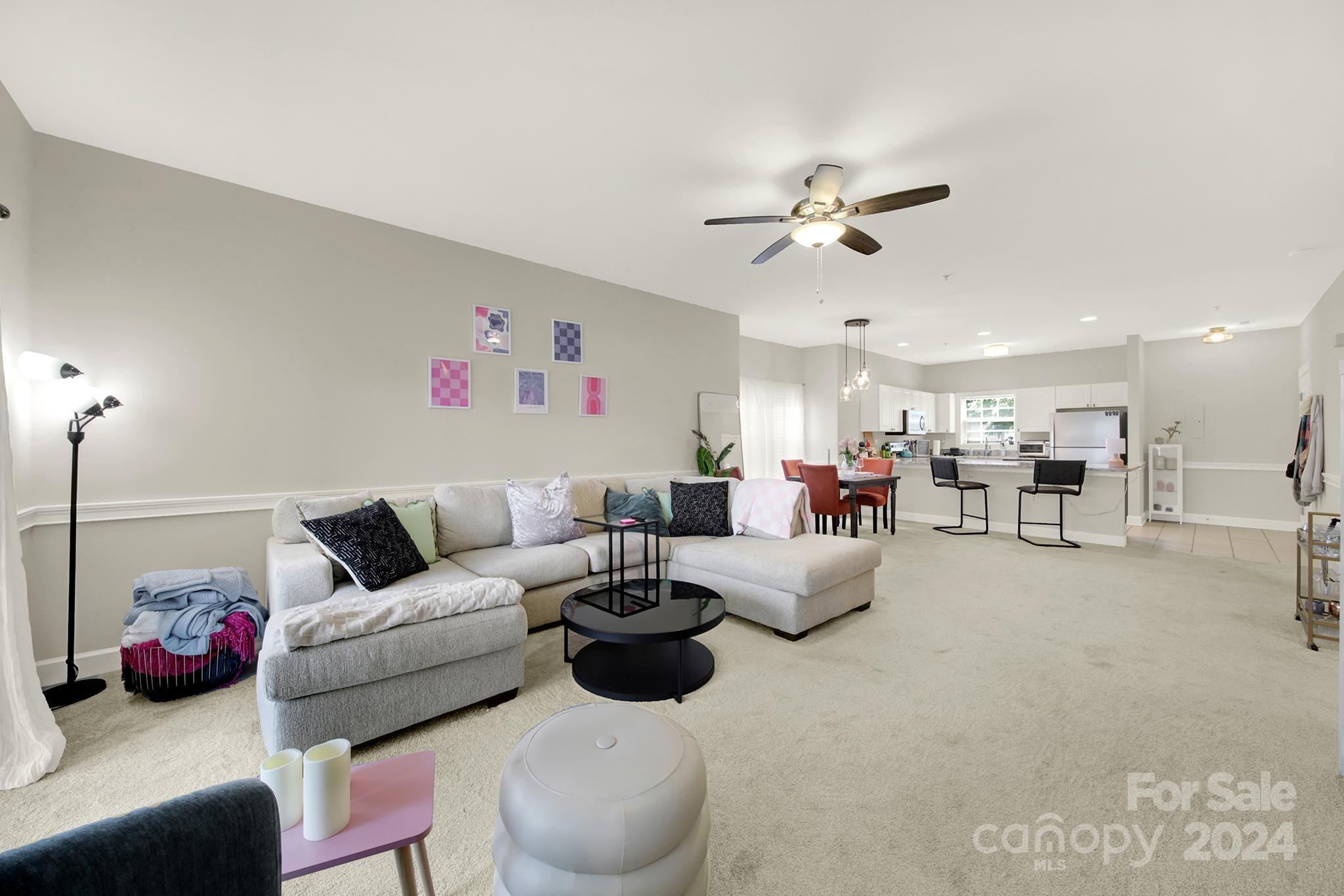 8959 Meadow Vista Road Charlotte, NC 28213 - Photo 15 of 32 a living room with furniture ceiling fan and a chandelier
