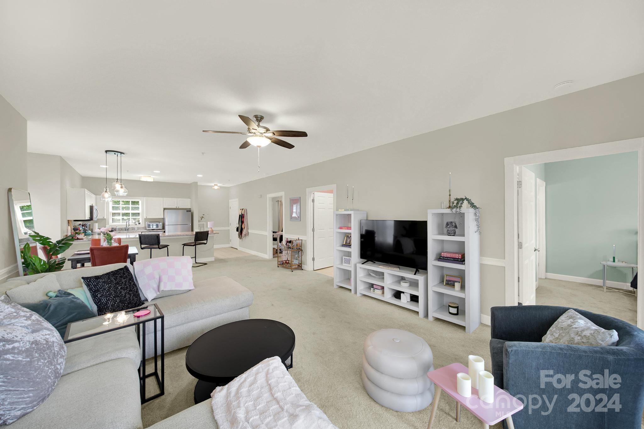 8959 Meadow Vista Road Charlotte, NC 28213 - Photo 16 of 32 a living room with furniture a flat screen tv and kitchen view