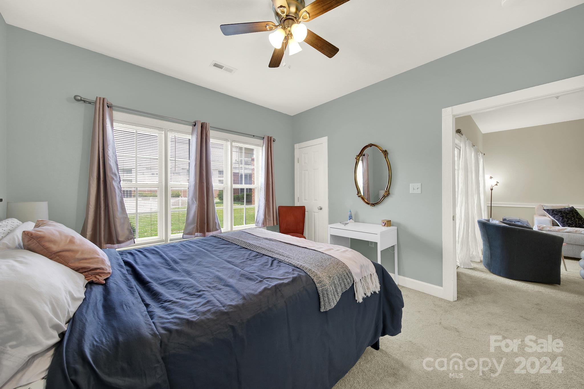 8959 Meadow Vista Road Charlotte, NC 28213 - Photo 18 of 32 a bedroom with a bed lamp closet and large window