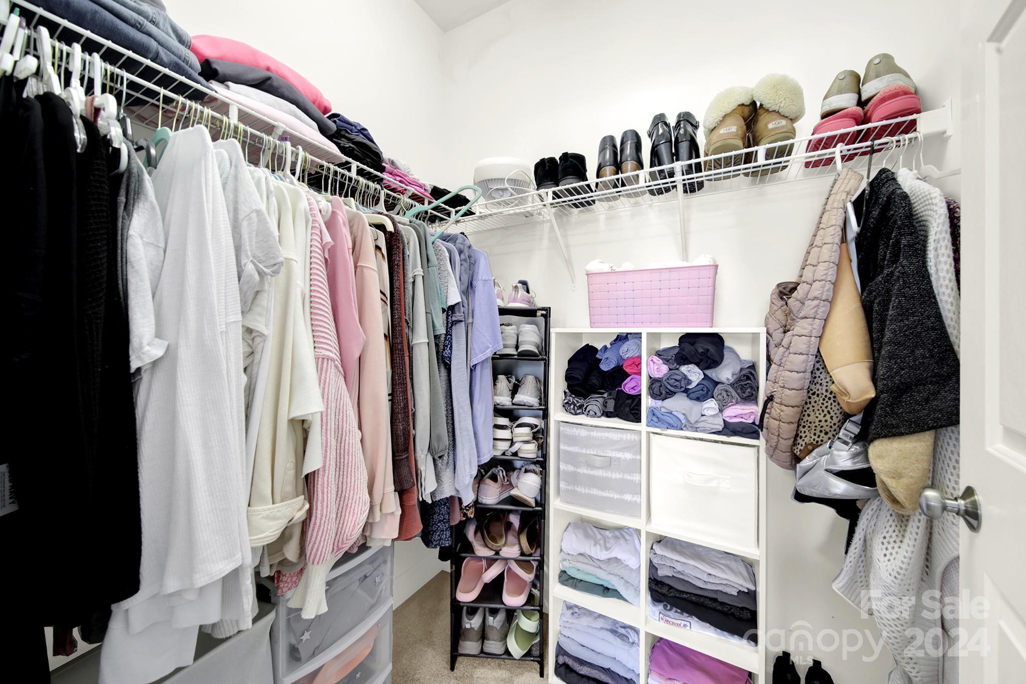 8959 Meadow Vista Road Charlotte, NC 28213 - Photo 21 of 32 a view of walk in closet with clothes and shoes