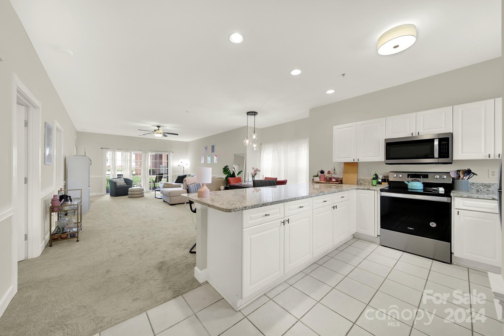 8959 Meadow Vista Road Charlotte, NC 28213 - Photo 4 of 32 a large white kitchen with cabinets a sink and appliances