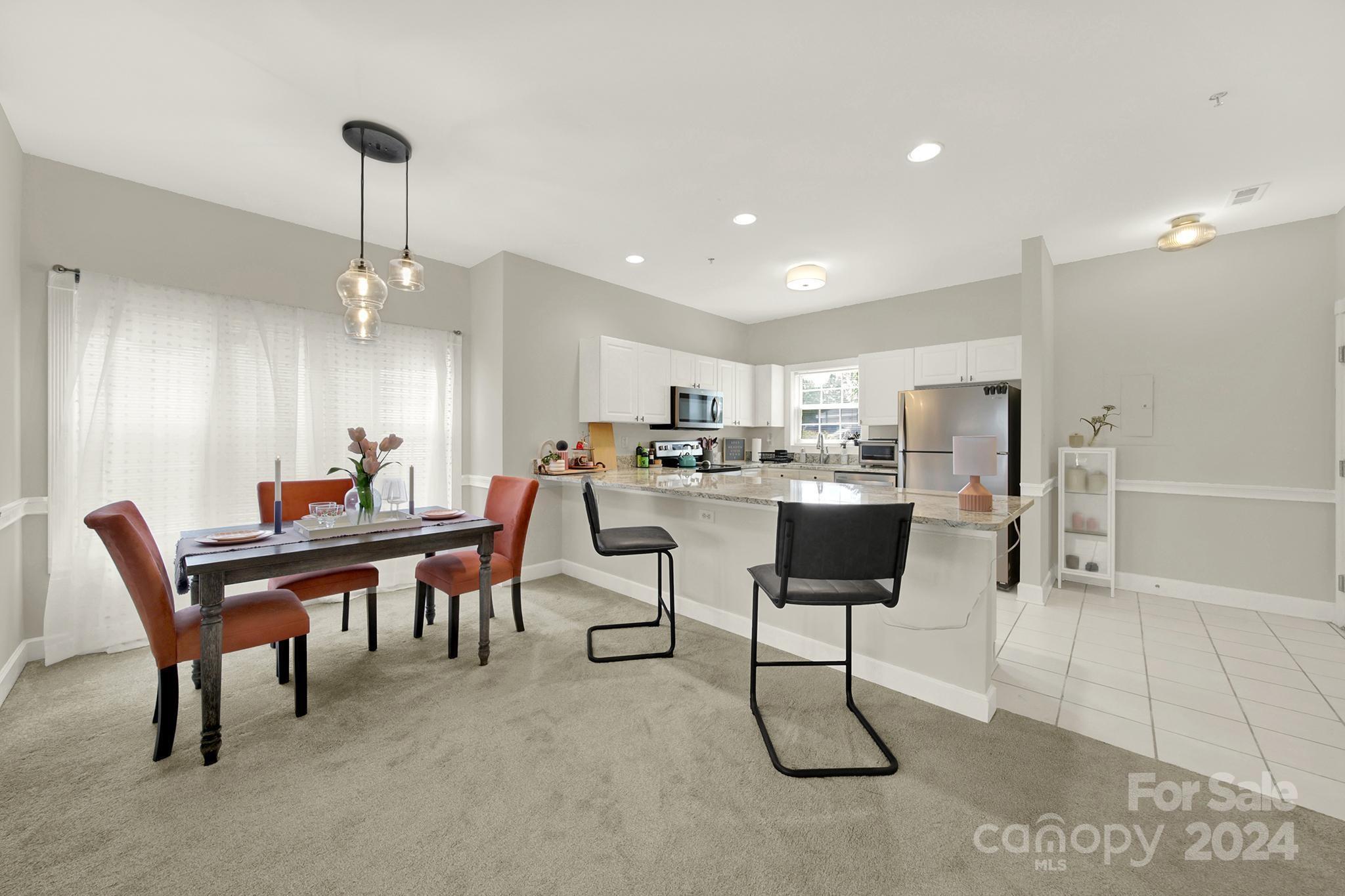 8959 Meadow Vista Road Charlotte, NC 28213 - Photo 5 of 32 a living room with stainless steel appliances kitchen island granite countertop furniture