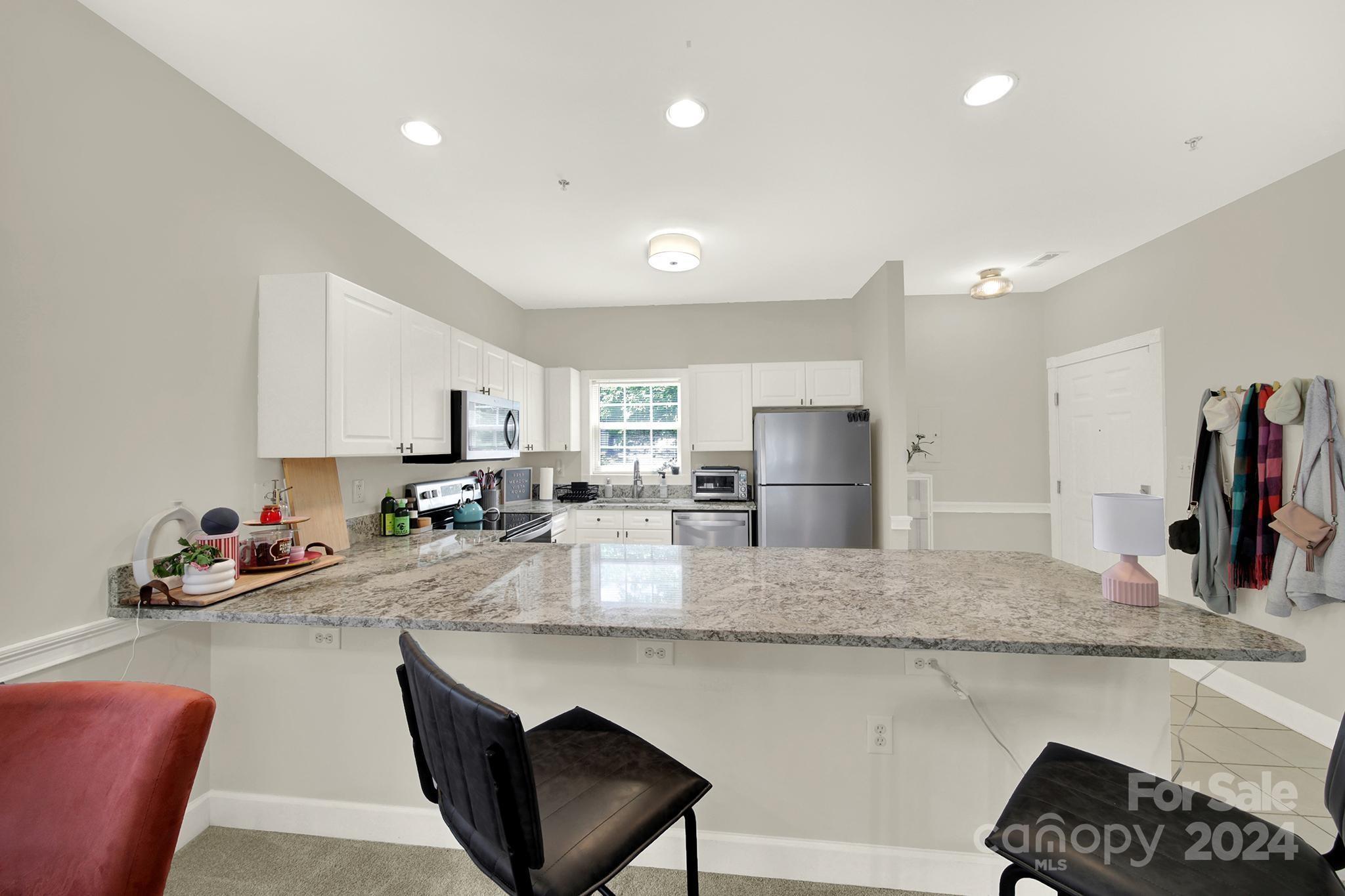 8959 Meadow Vista Road Charlotte, NC 28213 - Photo 7 of 32 a kitchen with counter top space cabinets and appliances