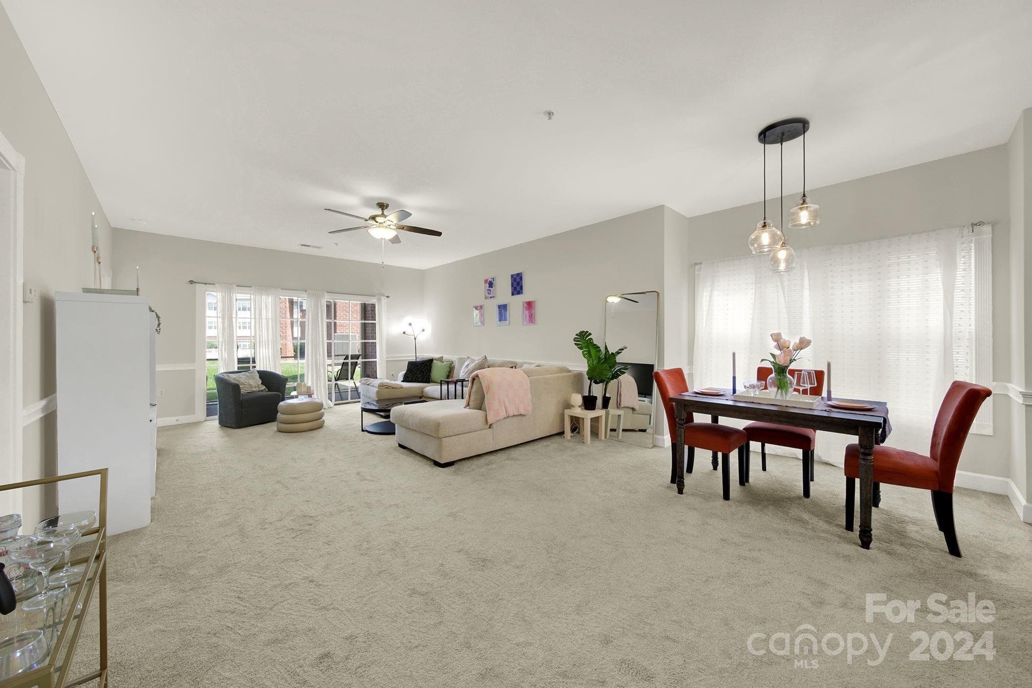 8959 Meadow Vista Road Charlotte, NC 28213 - Photo 8 of 32 a living room with furniture and a chandelier