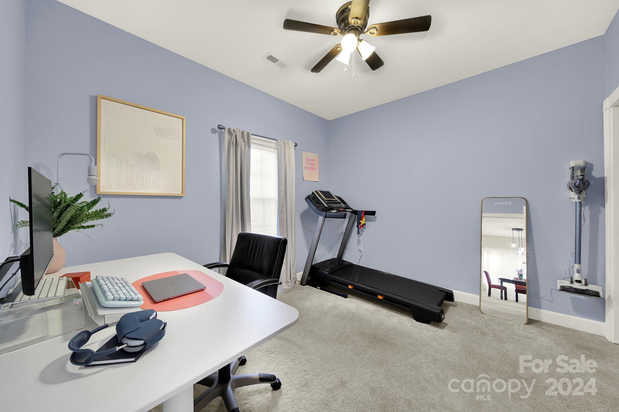 8959 Meadow Vista Road Charlotte, NC 28213 - Photo 9 of 32 a view of a workspace with furniture and gym equipment